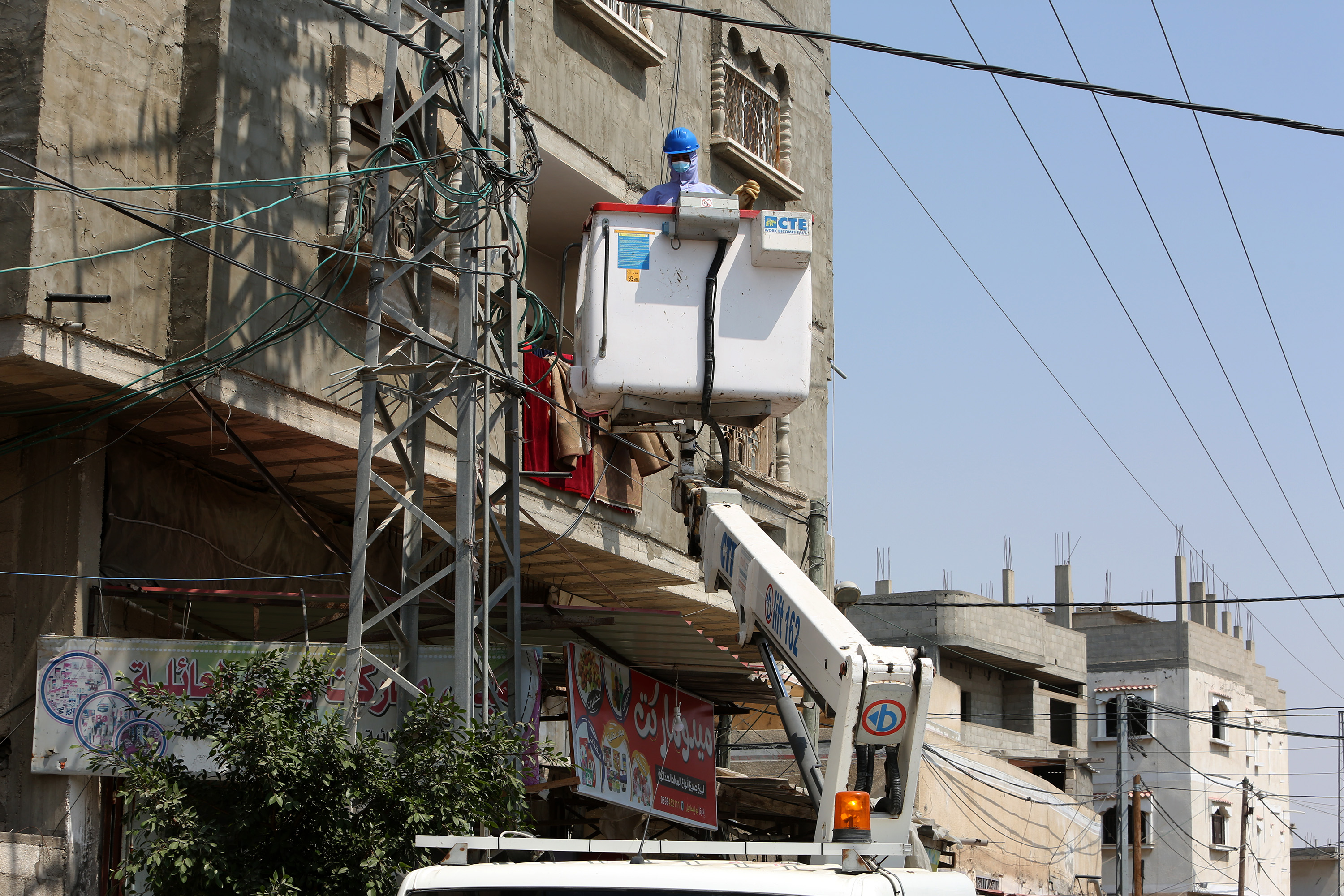 Palestinian workers in the electricity company work in the southern Gaza Strip in September 2020. (Stock photo)